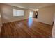 Spacious living room showcasing gleaming hardwood floors and a sliding glass door to the exterior at 11623 E Virginia Dr, Aurora, CO 80012