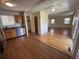 Open floor plan with wood floors seamlessly connecting the kitchen and living area at 11623 E Virginia Dr, Aurora, CO 80012