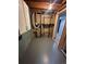 Basement utility room with exposed ductwork and plumbing, ideal for maintenance and storage, and painted floors at 11623 E Virginia Dr, Aurora, CO 80012