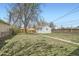 Spacious backyard featuring a detached garage and mature trees at 1649 Lima St, Aurora, CO 80010