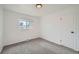 Clean, bright bedroom with neutral carpet and a window for natural light at 1649 Lima St, Aurora, CO 80010