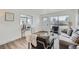 Bright living room featuring a sofa, chairs, console table, and a large window at 1649 Lima St, Aurora, CO 80010