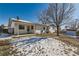 Spacious backyard with shed, partially covered patio and winter snow at 8839 Winona Ct, Westminster, CO 80031