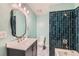 Updated bathroom with dark teal tile and a modern vanity at 8839 Winona Ct, Westminster, CO 80031