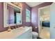 Bathroom with updated vanity, quartz countertop, and purple walls at 8839 Winona Ct, Westminster, CO 80031