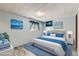Virtually staged bedroom with light blue walls and blue bedding at 8839 Winona Ct, Westminster, CO 80031
