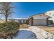 Brick ranch home with attached garage and landscaping, nestled on a snow-dusted lawn at 8839 Winona Ct, Westminster, CO 80031
