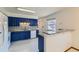 Kitchen with blue cabinets, granite countertops, and a breakfast bar at 8839 Winona Ct, Westminster, CO 80031
