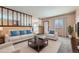 Virtually staged living room features a neutral color palette and comfortable seating at 8839 Winona Ct, Westminster, CO 80031