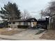 Damaged single-story home with fire damage to the garage and driveway, showing aftermath of a fire at 4672 S Lewiston Way, Aurora, CO 80015