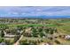 Aerial view of neighborhood surrounded by lush greenery and scattered residences at 1813 Pikes Peak St, Erie, CO 80516