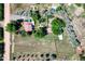 Aerial view of the property featuring a large lawn, mature trees, and a private pool at 1813 Pikes Peak St, Erie, CO 80516