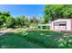 Backyard featuring lush lawn, mature trees, a shed and gardening features at 1813 Pikes Peak St, Erie, CO 80516