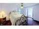 Bright bedroom featuring a metal frame bed, floral bedspread, and large windows at 1813 Pikes Peak St, Erie, CO 80516