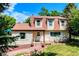 Quaint two-story home with decorative wagon wheel accenting the lovely front yard landscaping at 1813 Pikes Peak St, Erie, CO 80516