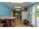 Bright kitchen features tile floors, breakfast bar, and access to the outdoor patio at 1813 Pikes Peak St, Erie, CO 80516