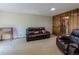 Comfortable living room with a vintage desk, wood paneling and plush leather seating at 1813 Pikes Peak St, Erie, CO 80516