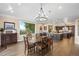 Bright dining room with large windows, chandelier, and hardwood floors at 26269 Richmond Hill Rd, Conifer, CO 80433