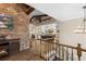 View of kitchen and entryway with exposed beams and brick fireplace at 26269 Richmond Hill Rd, Conifer, CO 80433