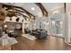 Living room with hardwood floors, fireplace, and access to sunroom at 26269 Richmond Hill Rd, Conifer, CO 80433