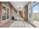 Sunroom with brick walls, tiled floor, and scenic views at 26269 Richmond Hill Rd, Conifer, CO 80433