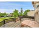 Elevated backyard deck features railing and an integrated hot tub with views of green lawn at 13008 Grove Way, Broomfield, CO 80020