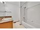 Bright bathroom featuring a tiled shower/tub and a vanity with a marble-style countertop at 13008 Grove Way, Broomfield, CO 80020