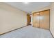 Bedroom features a light gray carpet, a double door closet, and neutral paint at 13008 Grove Way, Broomfield, CO 80020