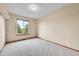 Bedroom with large window, and neutral walls and carpet at 13008 Grove Way, Broomfield, CO 80020