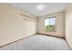 A bright bedroom with a window allowing natural light and built-in shelves for storage at 13008 Grove Way, Broomfield, CO 80020