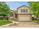 Beautiful two-story home with an attached garage, landscaped front yard, and neutral exterior at 13008 Grove Way, Broomfield, CO 80020