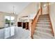Bright open kitchen features sleek white tile flooring, island and walk-out to the deck at 13008 Grove Way, Broomfield, CO 80020