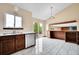 Modern kitchen features wood cabinets, stainless steel appliances, and sliding door access to the deck at 13008 Grove Way, Broomfield, CO 80020