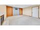 Spacious living room featuring built-in shelves, neutral paint, and carpet flooring at 13008 Grove Way, Broomfield, CO 80020