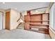 Living area with staircase, built-in shelves, and cozy carpet at 13008 Grove Way, Broomfield, CO 80020