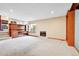 Bright living room with fireplace, built-in shelves, and adjacent kitchen area at 13008 Grove Way, Broomfield, CO 80020