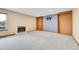 Open living room with fireplace, built-in shelves, and light neutral carpet flooring at 13008 Grove Way, Broomfield, CO 80020