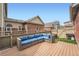 Inviting backyard features a wooden deck with comfortable seating and lush green grass at 14732 E Poundstone Dr, Aurora, CO 80015