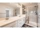 Elegant bathroom with a double sink vanity, tile backsplash, and glass-enclosed shower at 14732 E Poundstone Dr, Aurora, CO 80015