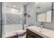 Modern bathroom featuring a glass shower door, decorative tile, and a stylish vanity with a vessel sink at 14732 E Poundstone Dr, Aurora, CO 80015