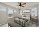 Bright bedroom featuring large windows, a bed, and light-colored walls at 14732 E Poundstone Dr, Aurora, CO 80015