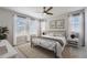 Well-lit bedroom with a ceiling fan, two windows, and an iron-framed bed at 14732 E Poundstone Dr, Aurora, CO 80015