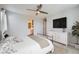 A neutral bedroom with a TV and a view of a bathroom at 14732 E Poundstone Dr, Aurora, CO 80015