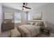 Comfortable bedroom featuring neutral decor, large windows, and a cozy bed setup at 14732 E Poundstone Dr, Aurora, CO 80015
