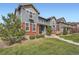 Charming two-story home featuring a well-maintained lawn and partial brick facade under a clear blue sky at 14732 E Poundstone Dr, Aurora, CO 80015