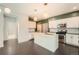 Well-lit kitchen showcasing a center island, stainless steel appliances, and an open layout at 14732 E Poundstone Dr, Aurora, CO 80015