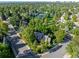 Aerial view of home surrounded by lush greenery and mature trees in neighborhood at 7001 S Newport St, Centennial, CO 80112
