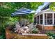 Charming backyard with brick patio, table with umbrella, and manicured landscaping at 7001 S Newport St, Centennial, CO 80112
