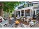 Relaxing backyard with brick patio, fire pit, white Adirondack chairs, and lush landscaping at 7001 S Newport St, Centennial, CO 80112
