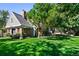 Expansive backyard featuring a lush lawn and mature trees creating a private and serene outdoor space at 7001 S Newport St, Centennial, CO 80112
